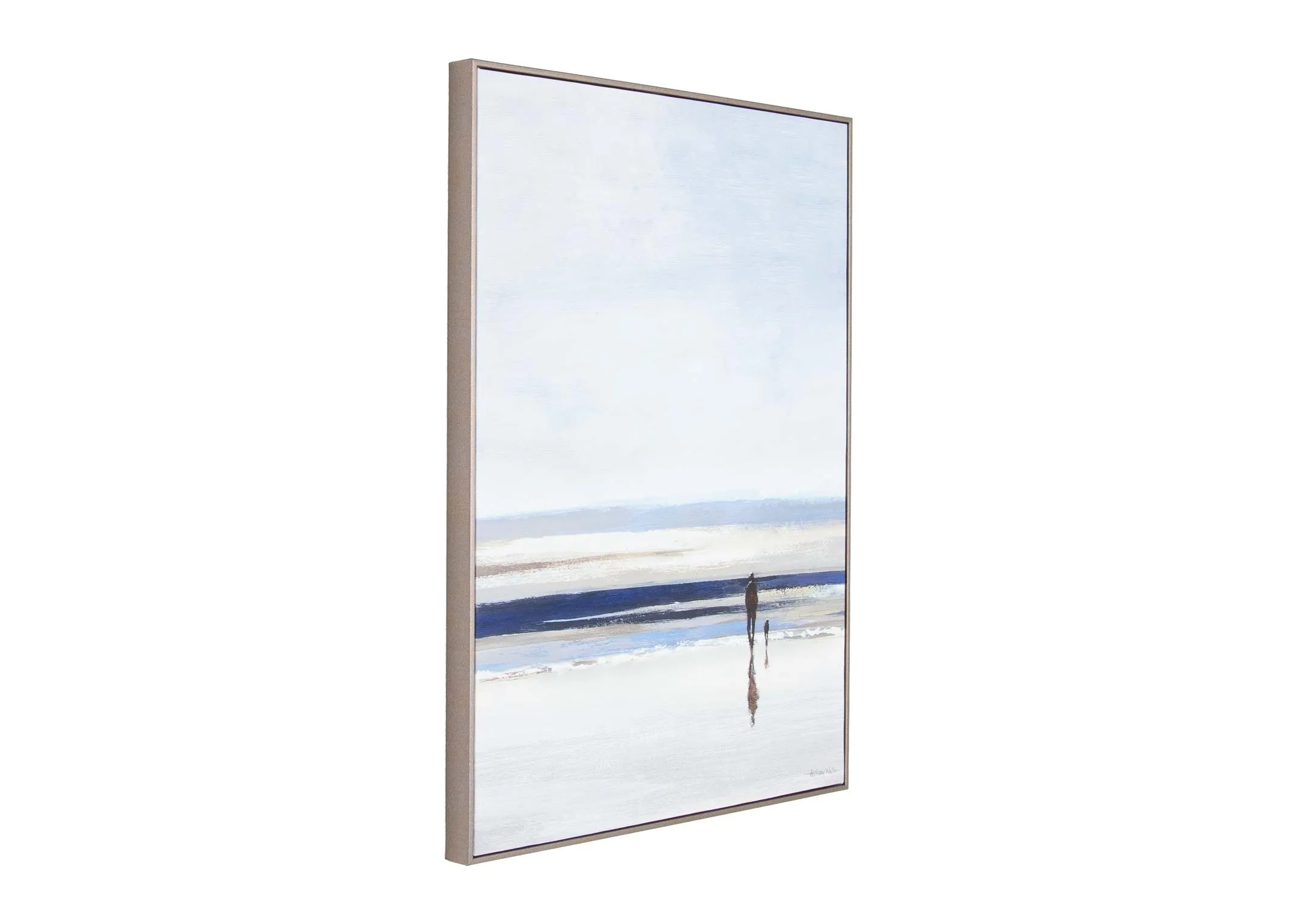 A silver framed canvas of an ocean with a person strolling toward from EZ Living's Shoreline range.  Angled view