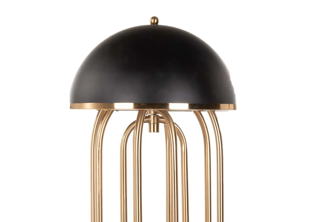 A gold metal art deco table lamp with black hard shade from EZ Living's Dixie range. Closeup of hard shade