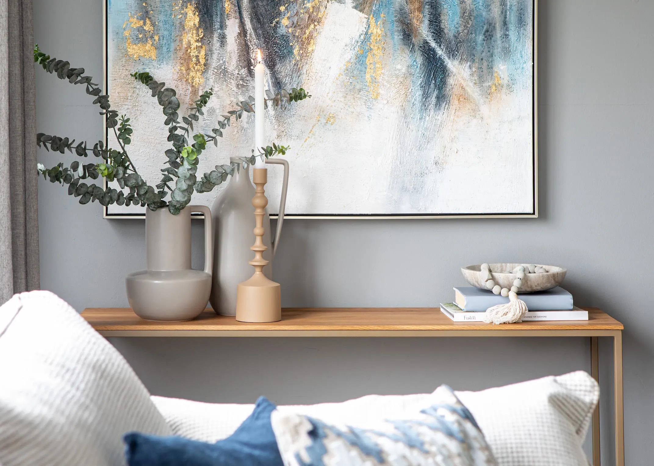 A lifestyle image of the Aston Console table with Cecilia & Valentina vase & Abstract canvas