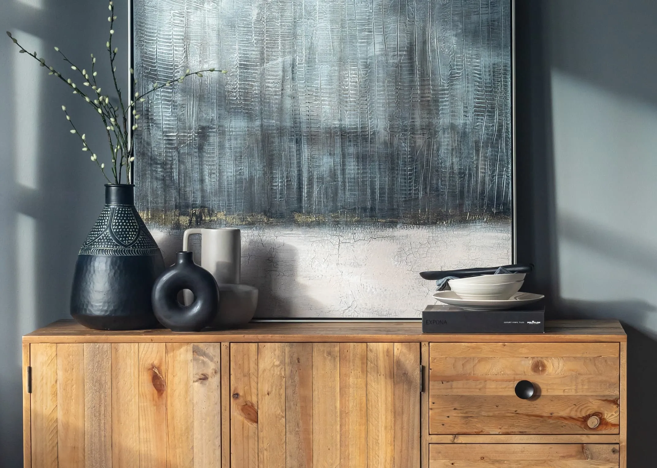 A lifestyle image of the San Francisco sideboard with Tones of Grey Print with vita vases 