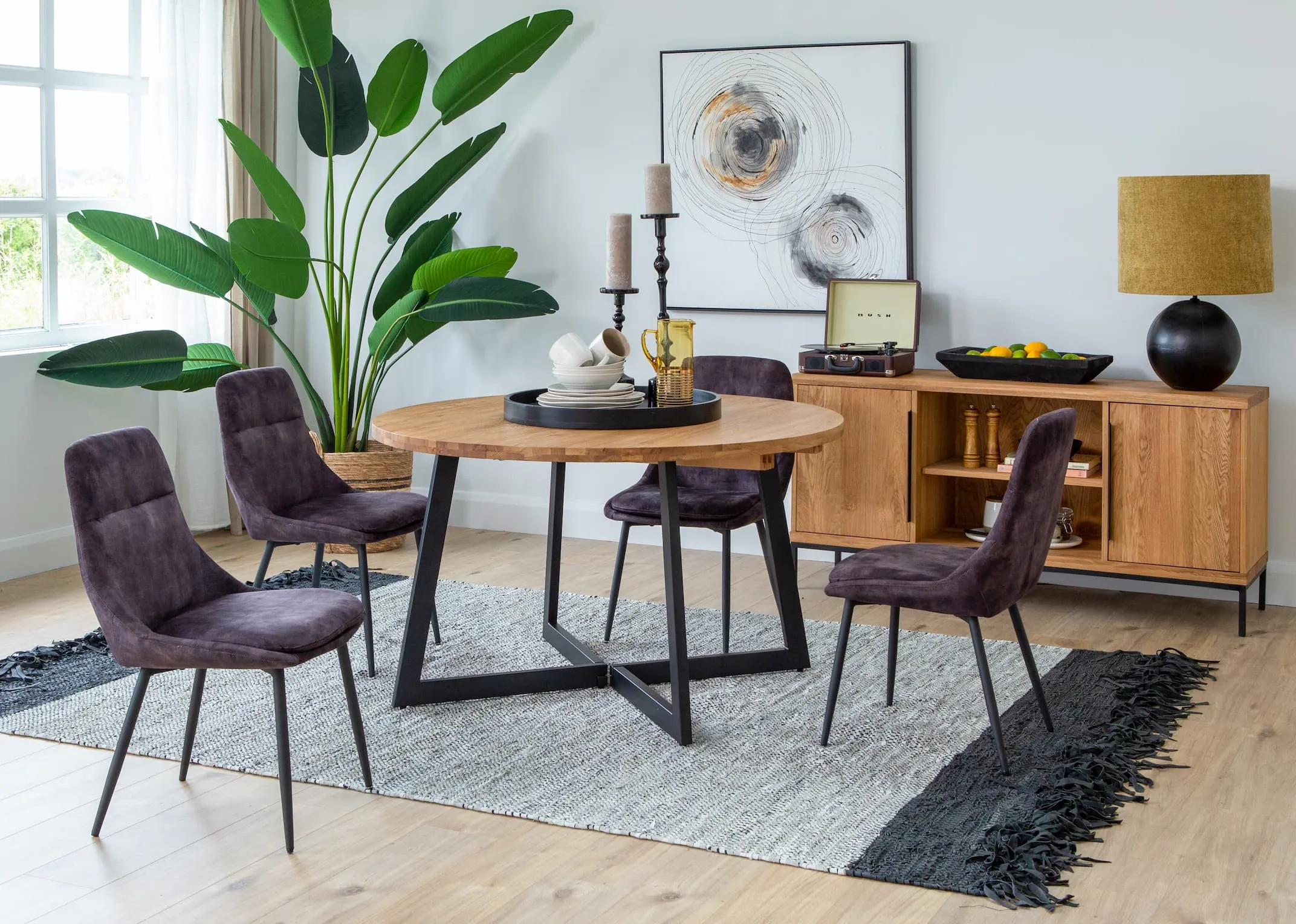 A lifestyle image of the Renvyle table paired with Bohemian chairs and Renvyle sideboard