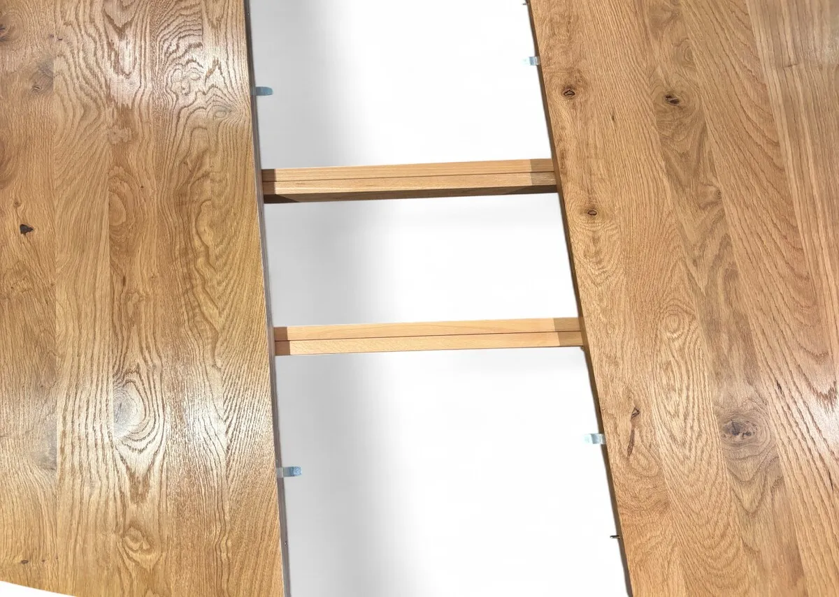 An oak round to oval extendable dining table from EZ Livings Renvyle range. Closeup pf wood textrue