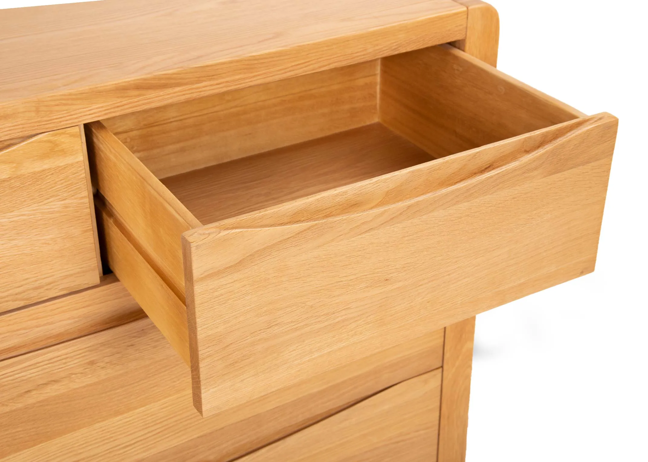 An oak chest of drawers from EZ Livings Iris range.  Angled closeup of soft close drawer