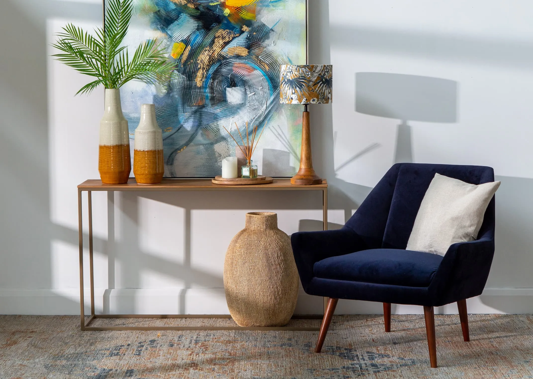 An aston console table with infusion canvas displaying Frasca vases & Mashaba Brown vases underneath & Jovany Lamp