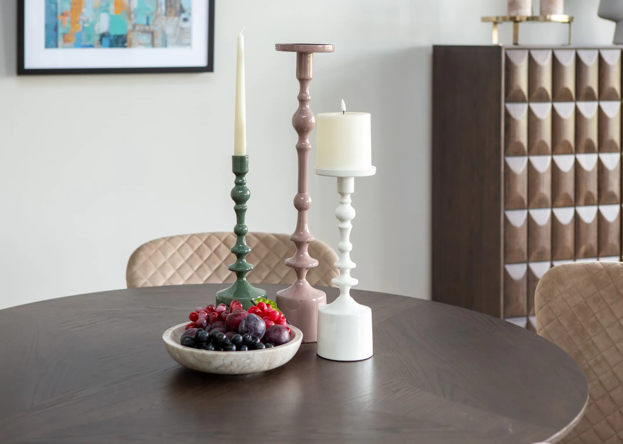 A lifestyle image of the Sheva Candleholders in green