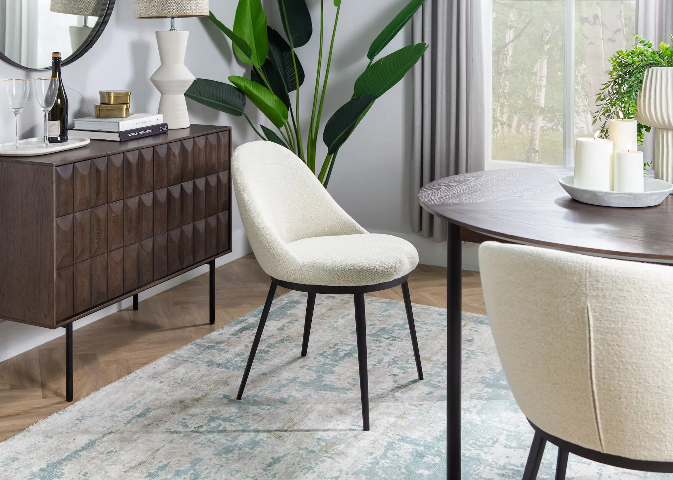 A lifestyle image of the Gain dining chair with the Latina round dining table & sideboard.