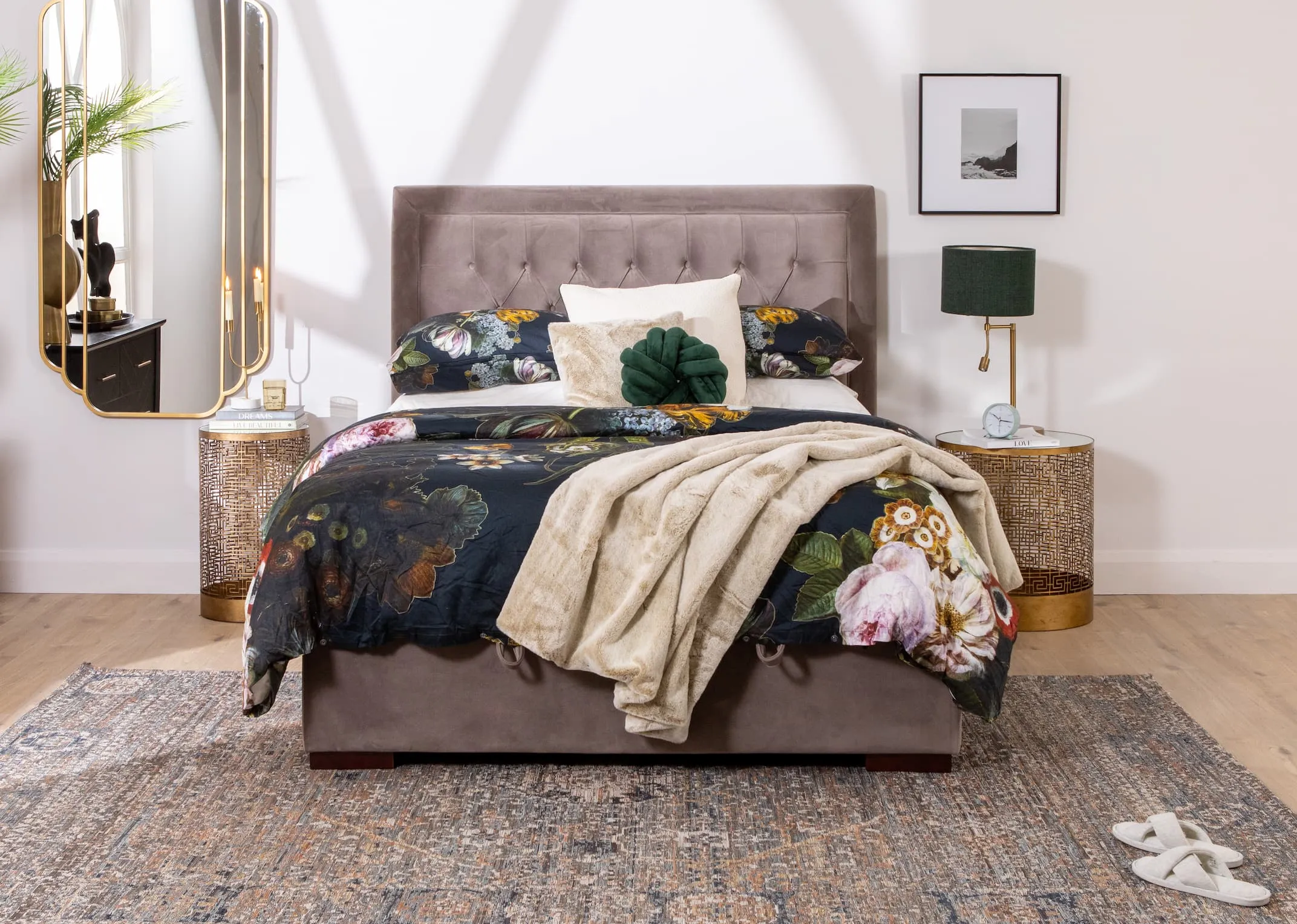 A lifestyle image of the Majestic taupe bed closed to reveal under bed storage and chevron black chest of drawers
