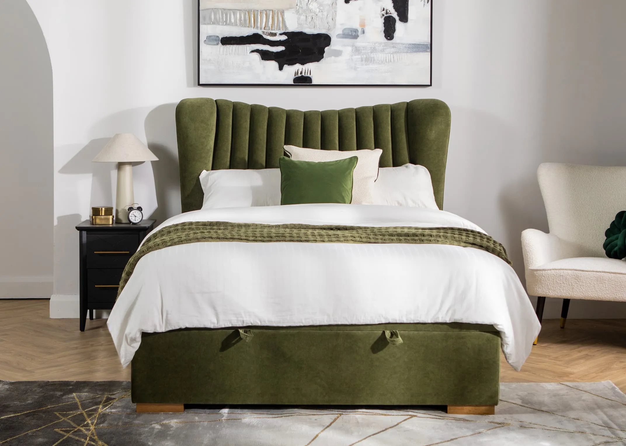 A lifestyle image of the Robin velvet ottoman with chevron black locker