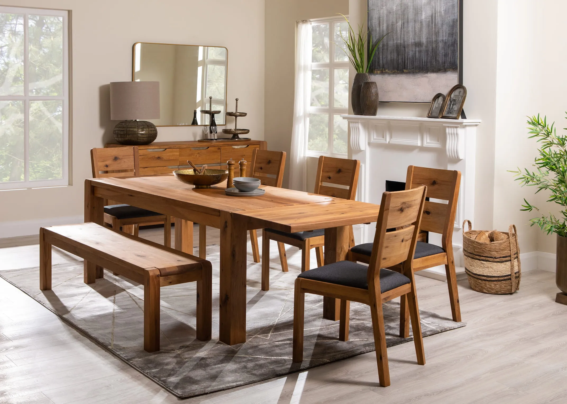 A lifestyle image of the Como dining table and chairs with Sideboard and Fern gold mirror.