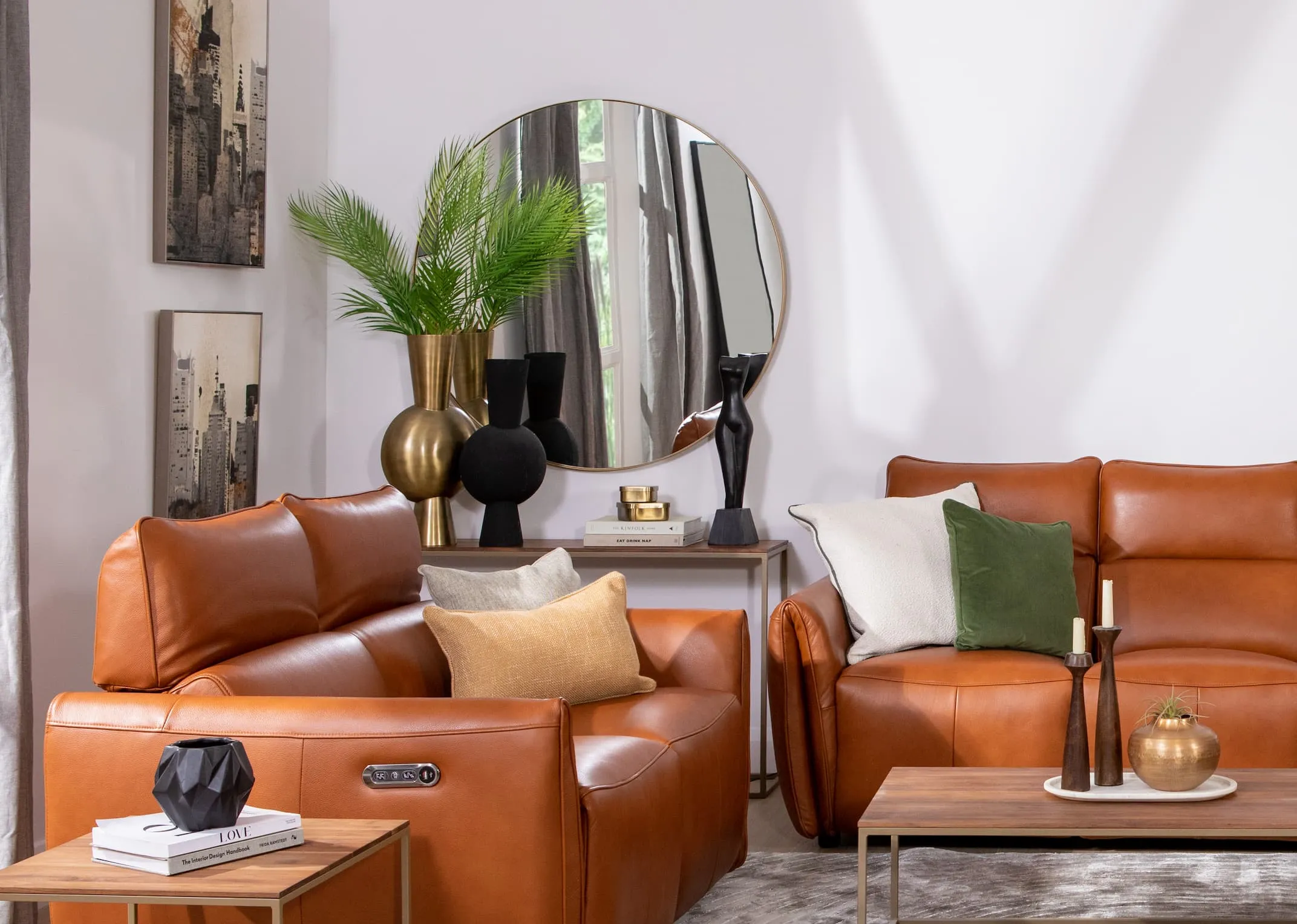 A lifestyle image of the Icon Brown recliners with Aston walnut table swith Elling Gold mirror