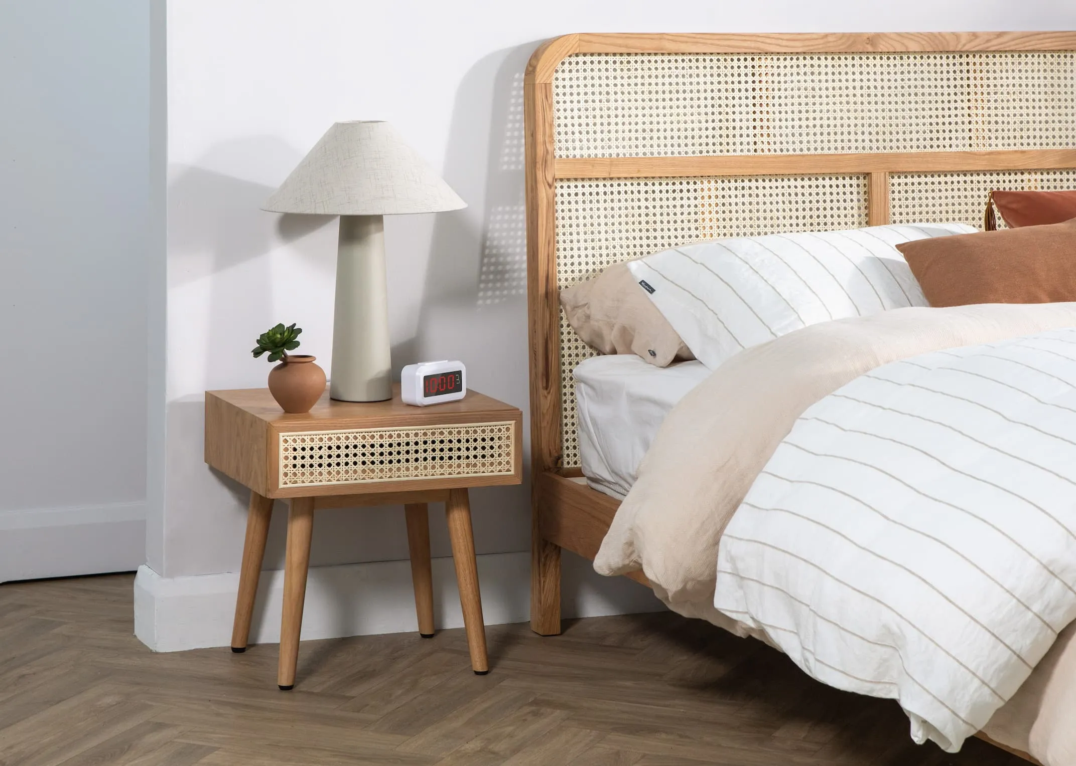 A lifestyle image of the Sacramento bedframe with side locker and Daisy lamp on.