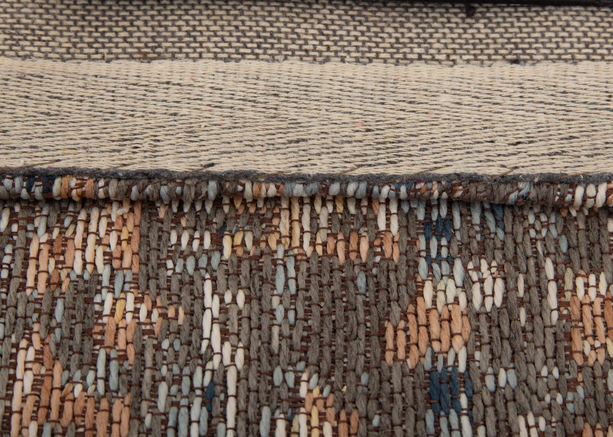 A rust grey & silver print rug from EZ Livings Maxima range. Closeup of woven fabric