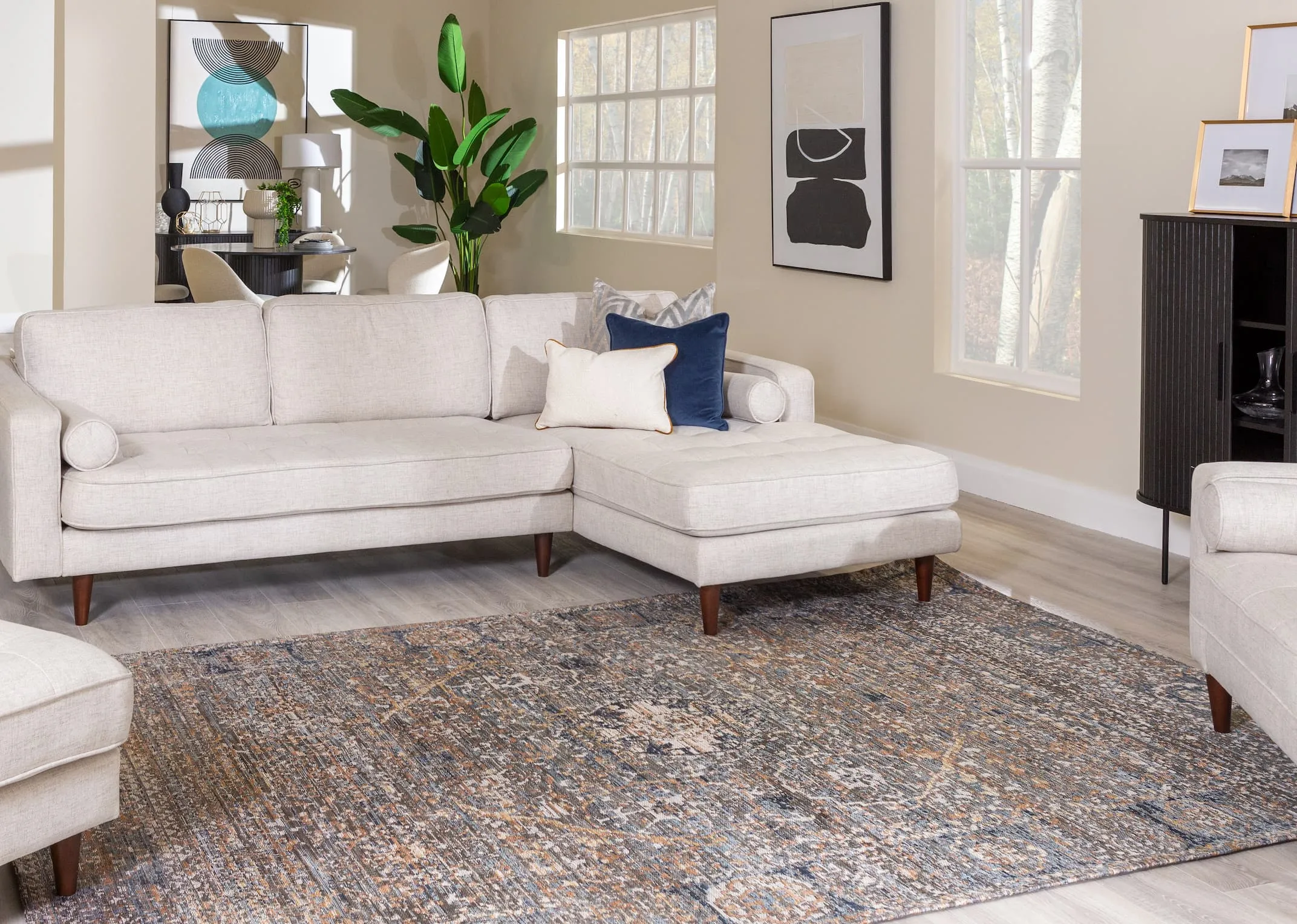 A lifestyle image of the Genoa corner sofa with Nola black cabinet with Maxima rug.