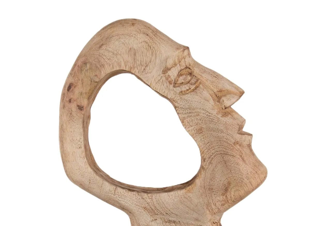 A wood face ornament with a carved out space from EZ Livings Masimo range. Closeup of carved circle in centre of face