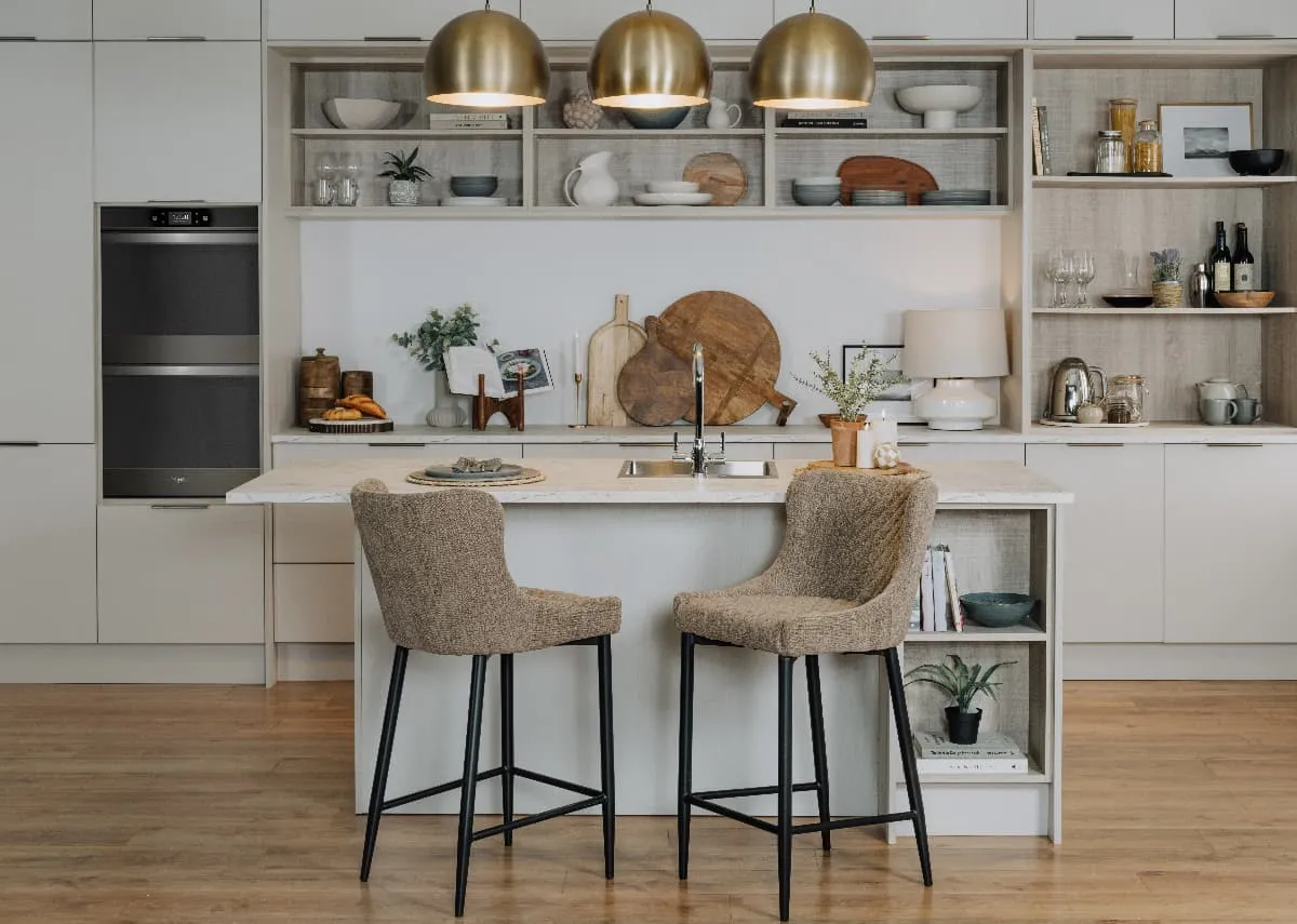A lifetsyle image of the Jaicey Ceiling lamp over a kitchen island with the Dylan taupe bar stools.