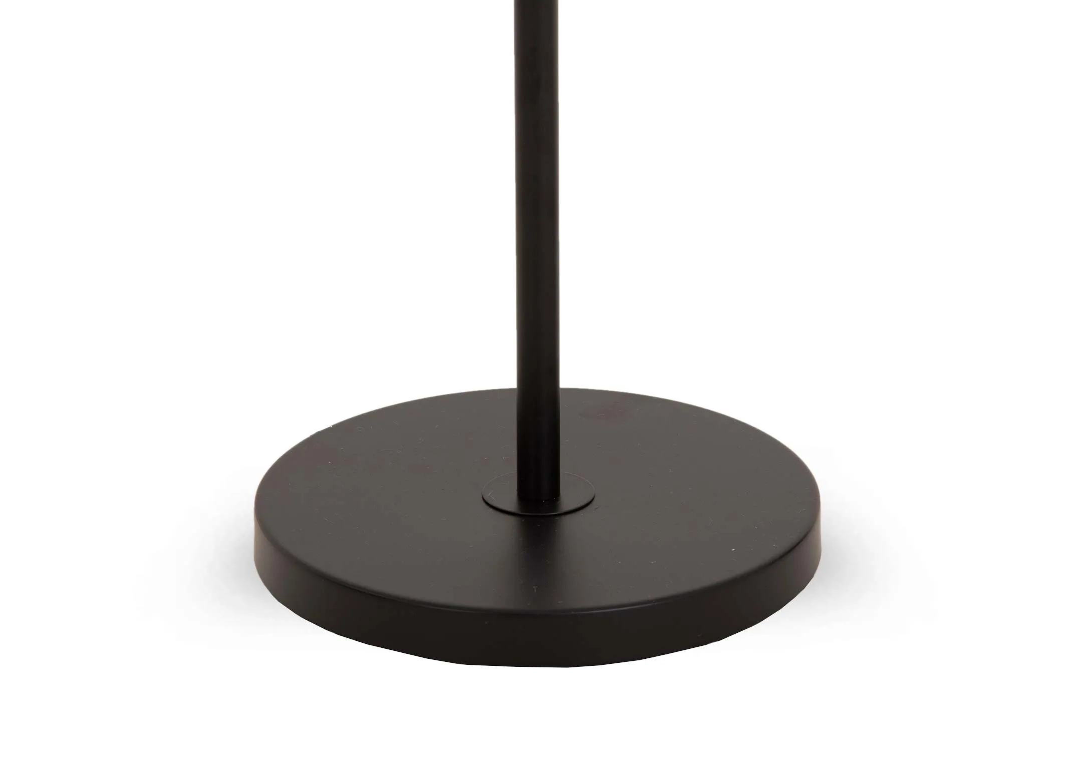 A black metal floor lamp with smoked grey glass shade from EZ Livings Leanne range. Closeup of round base