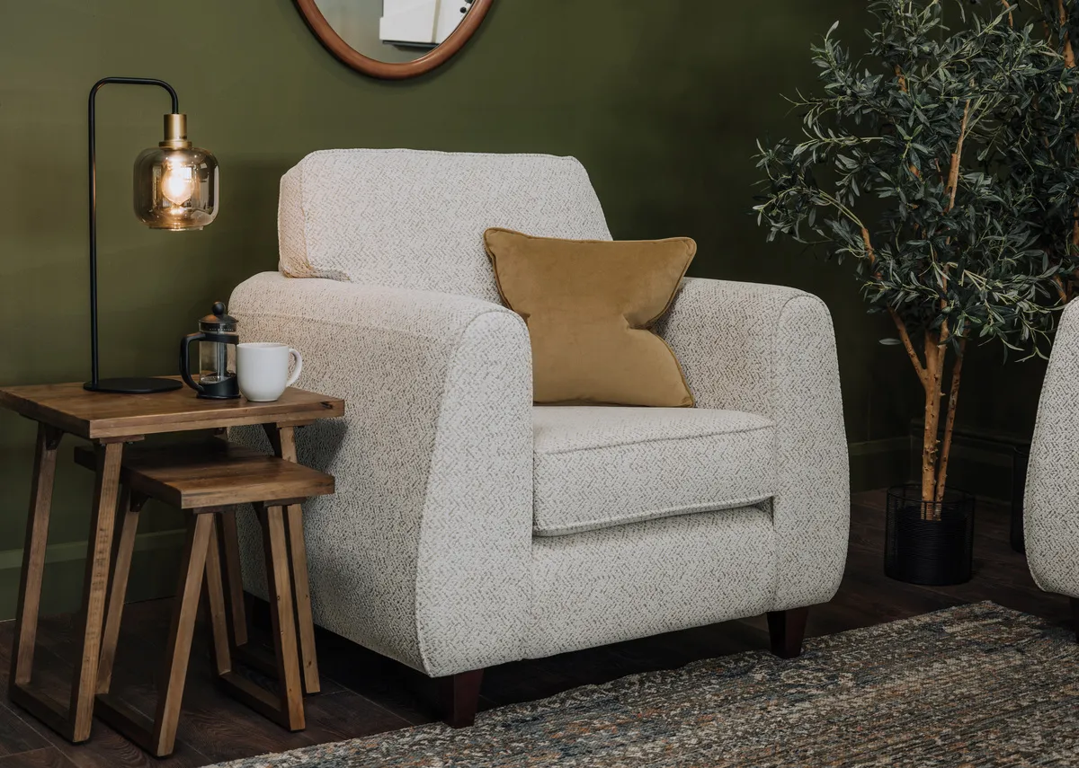 A lifestyle image of the Waterville armchair with Ladder nests and Lekar table lamp.