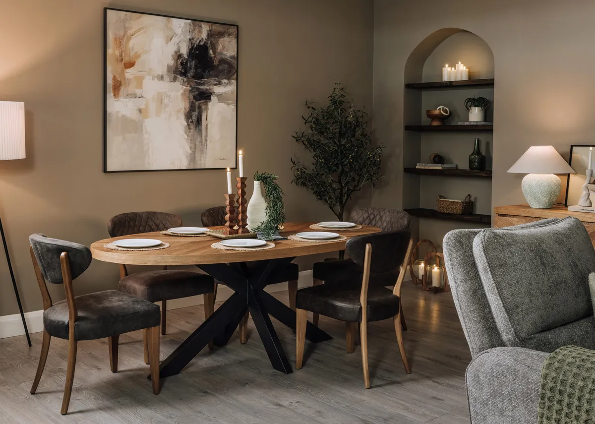 A lifestyle image of the Ellipse dining table with matching chairs and Evocative print.