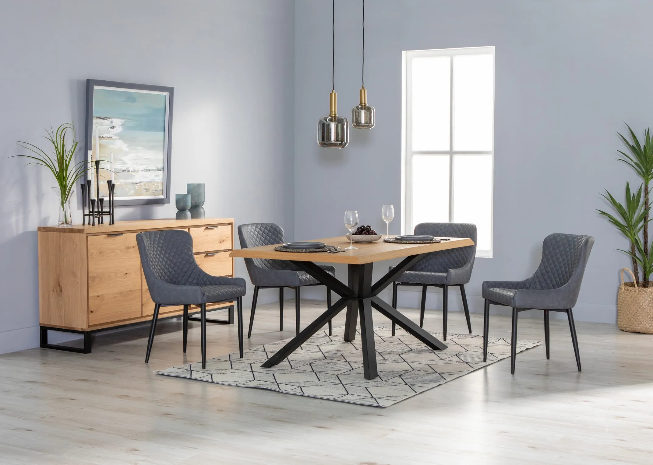 A lifestyle image of the Arno oak dining table with Ottowa grey dining chairs and sideboard.