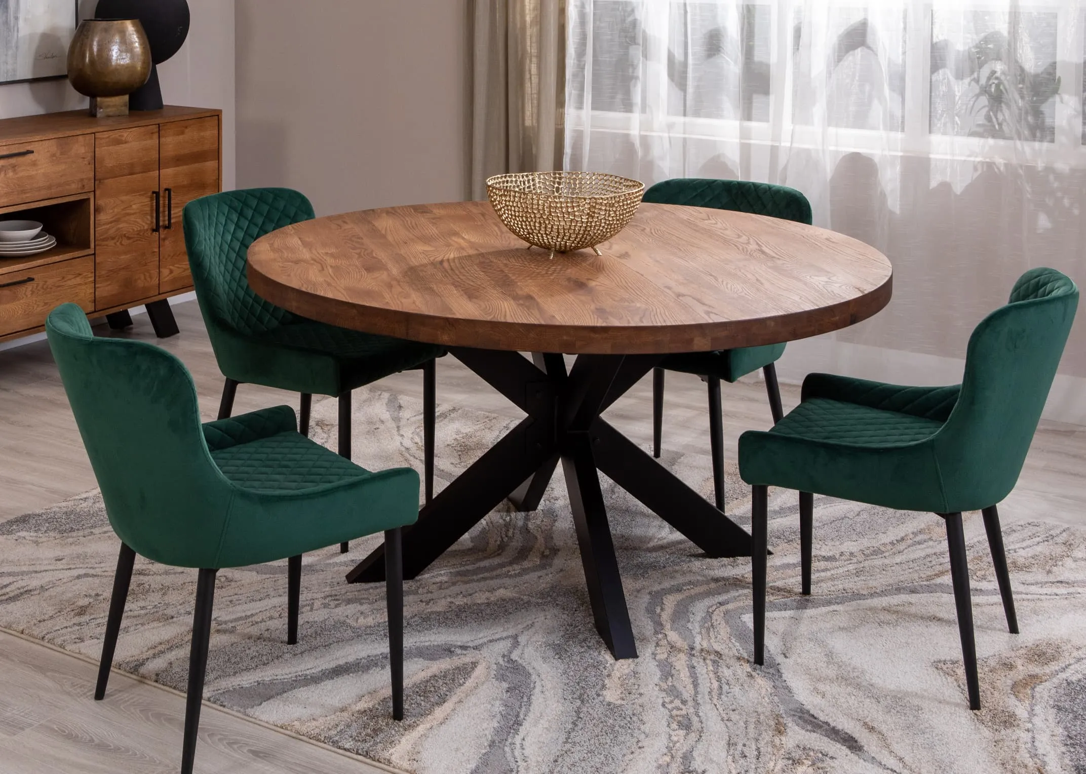 A lifestyle image of the Oslo Round dining table with Ottowa green dining chairs.