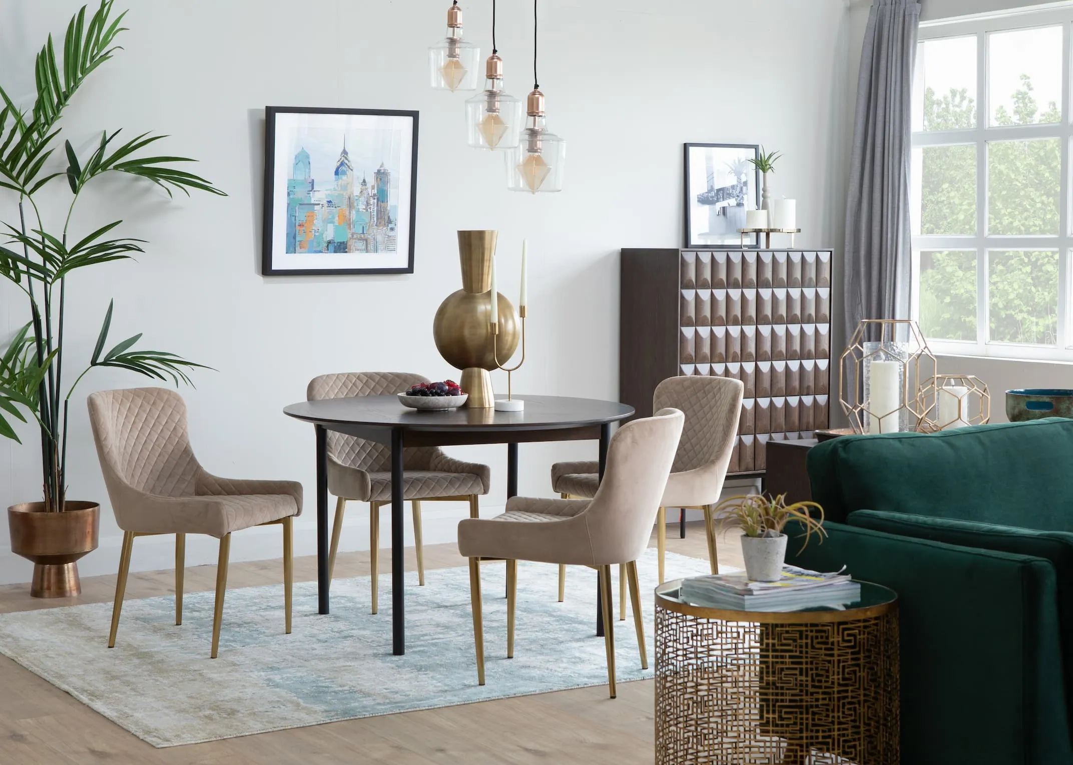 A lifestyle image of the Latina round dining table with Ottowa Taupe dining chairs and latina drinks cabinet.