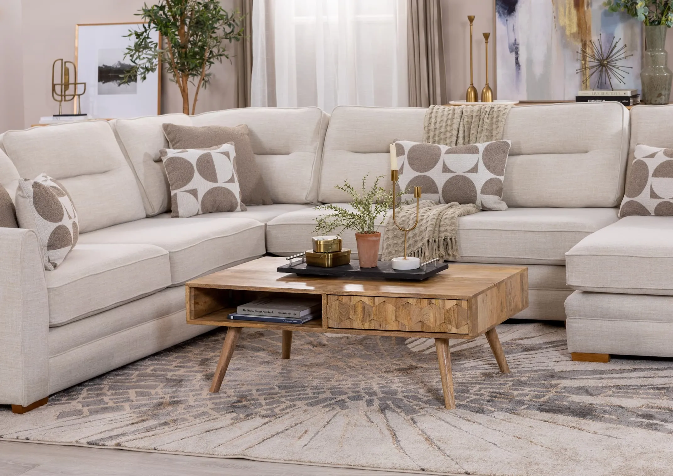 A lifetsyle image of the Cologne coffee table with the Brianna corner sofa dressed with tray of candles and plants