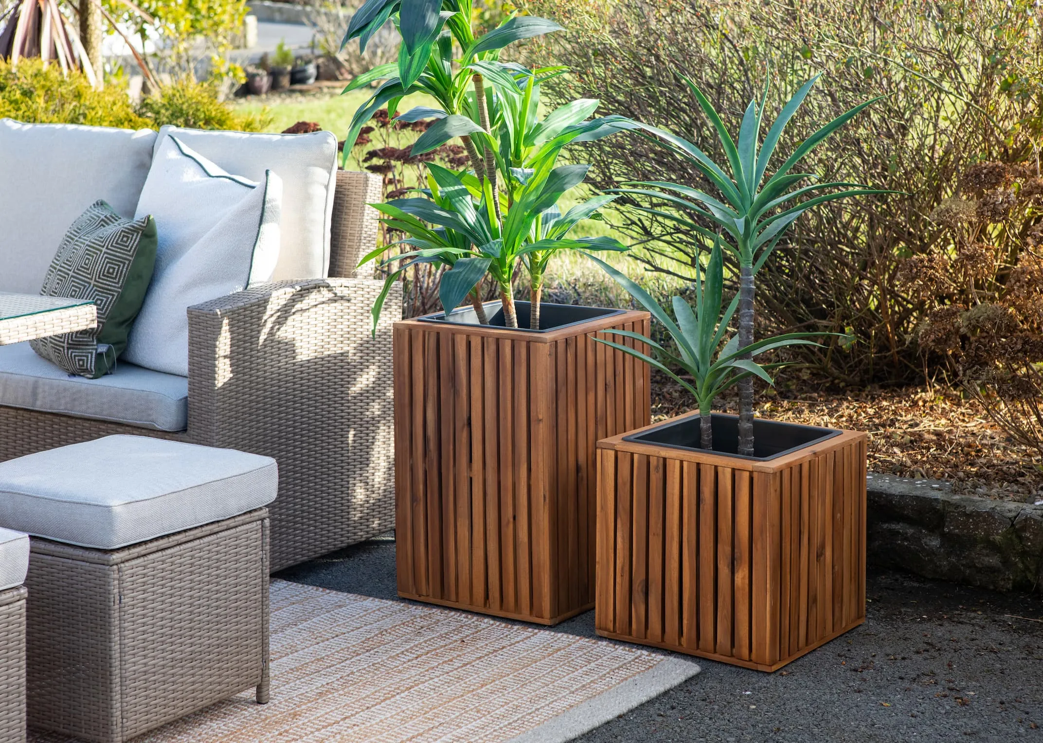 A lifestyle image of the Small & Medium Santa Cruz planters in an Outdoor setting with the Malaga Garden set