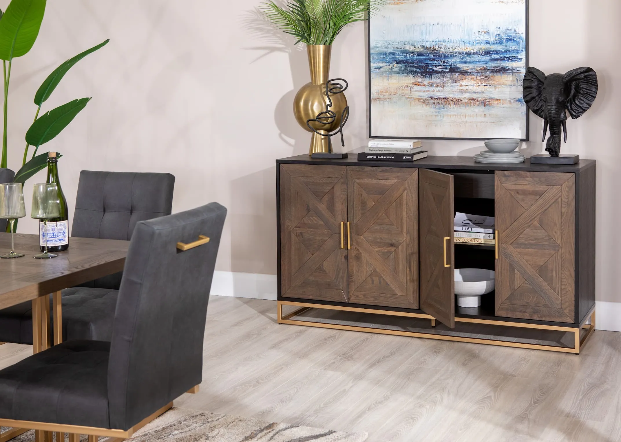 A lifestyle image of the Greenwich Sideboard with Kavandu vase & Elephant bust with door open showing storage space