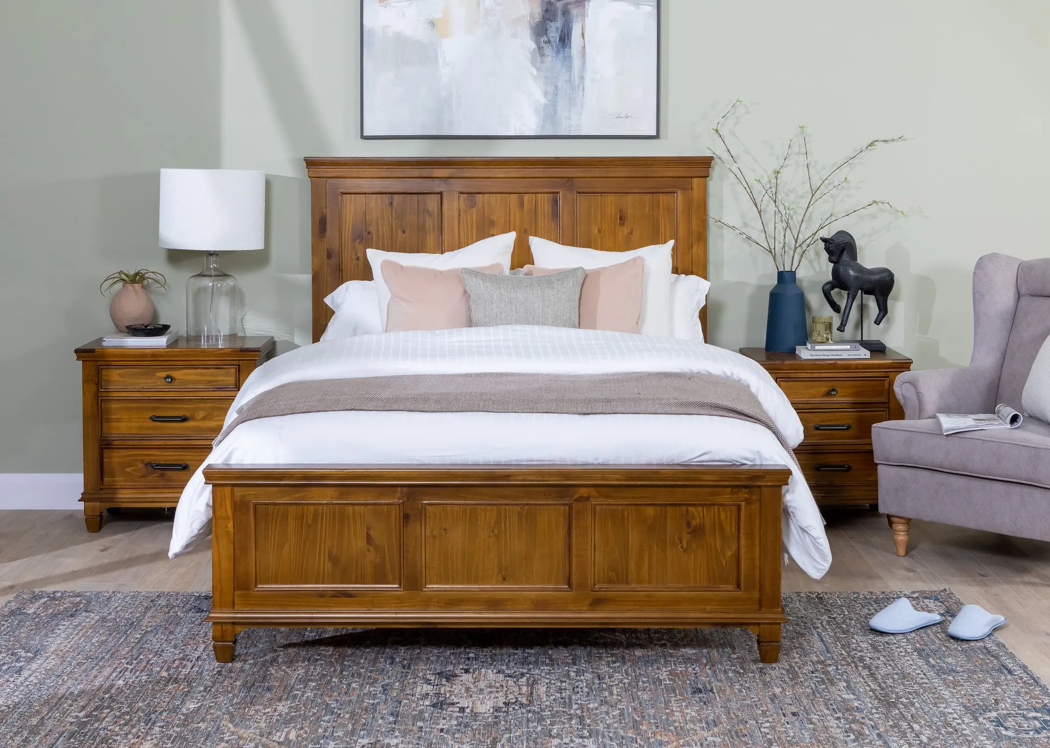 A lifestyle image of the Allyson bedframe with maxima rug and astoria chair with Pali lamp
