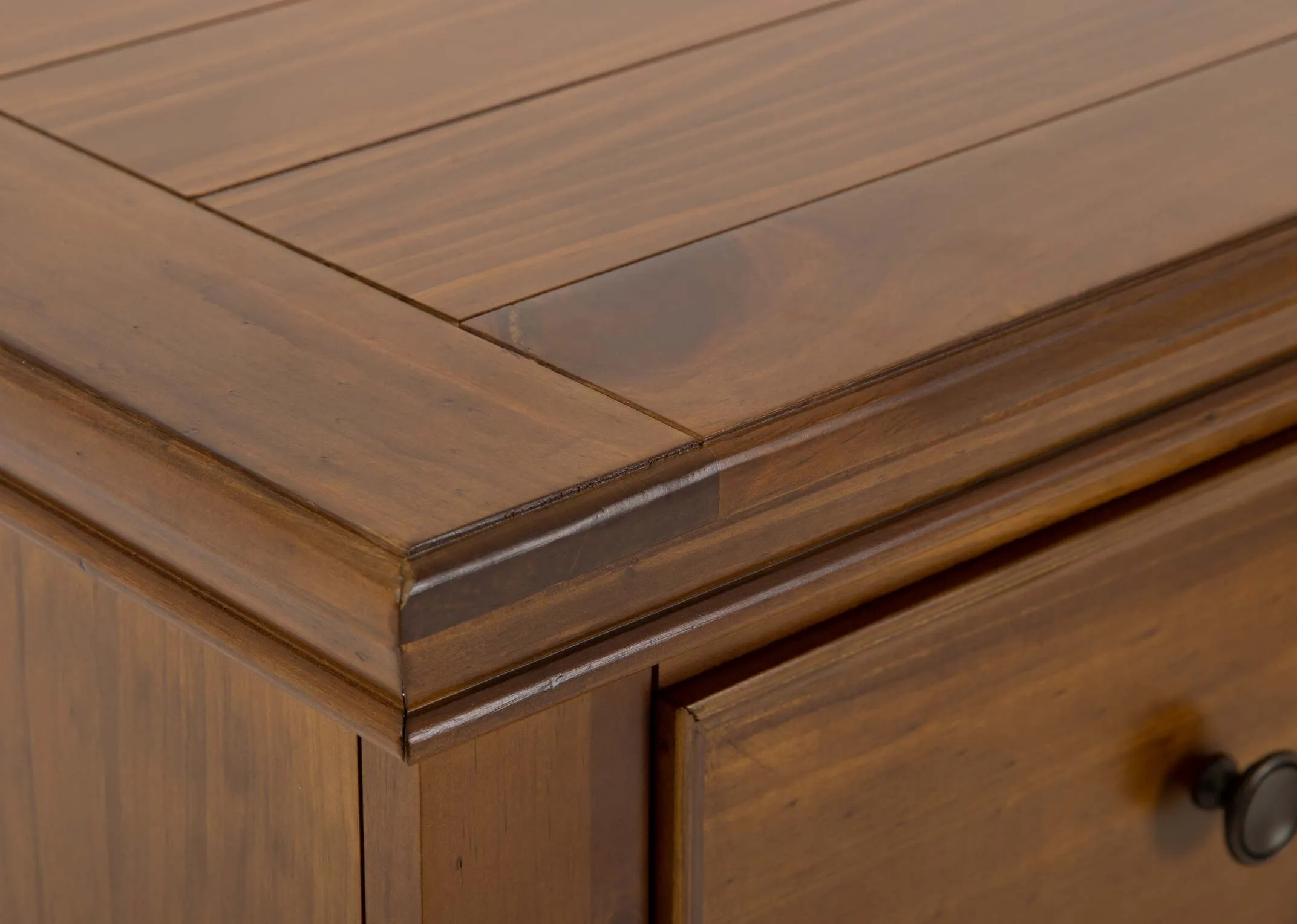 A brown pine wood 5 drawer chest from EZ Livings Allyson range. Closeup of slat wood top