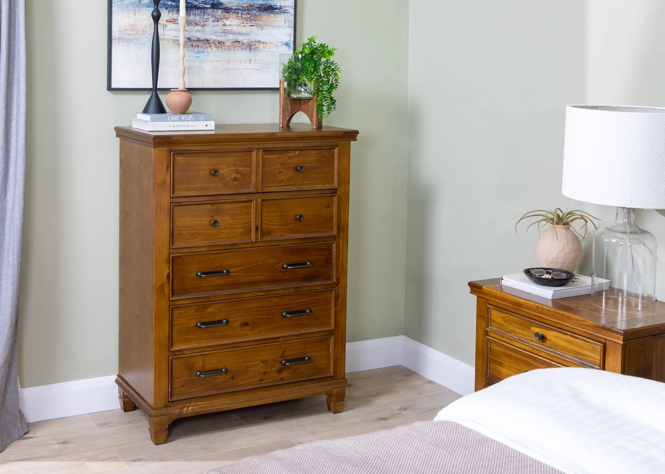 A lifestyle image of the Allyson chest with matching locker & bedframe and Fearless canvas