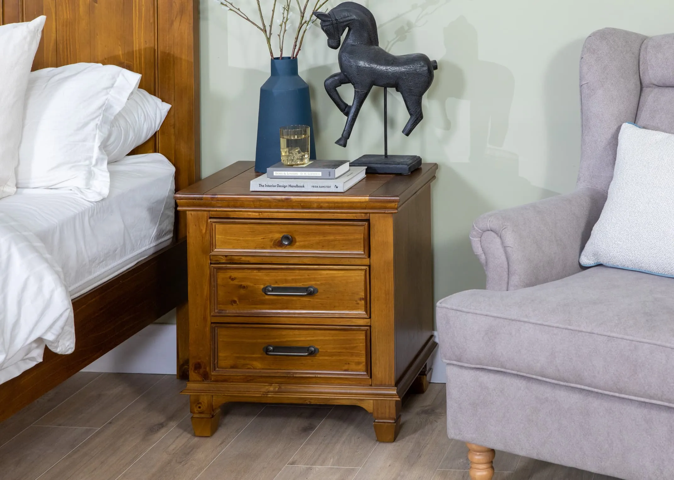 A lifestyle image of the Allyson small locker with the matching bedframe and astoria chair
