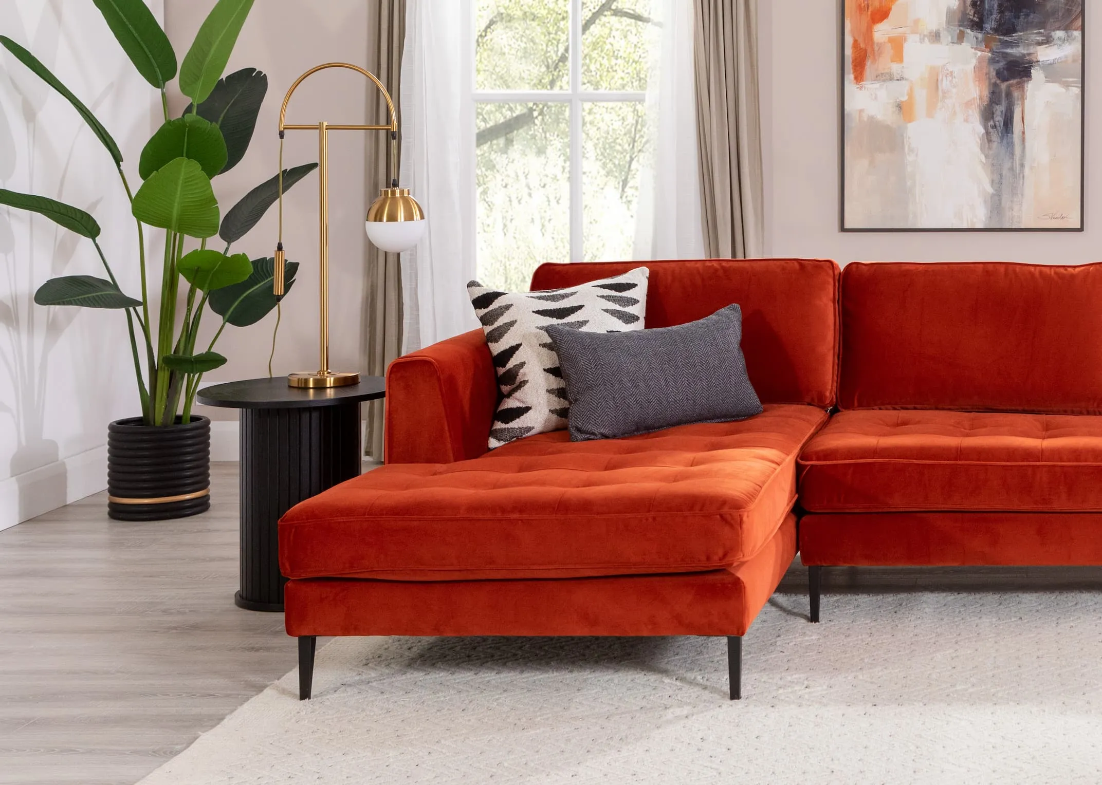 A lifestyle image of the Casper table lamp with Nola side table and Tierra chaise