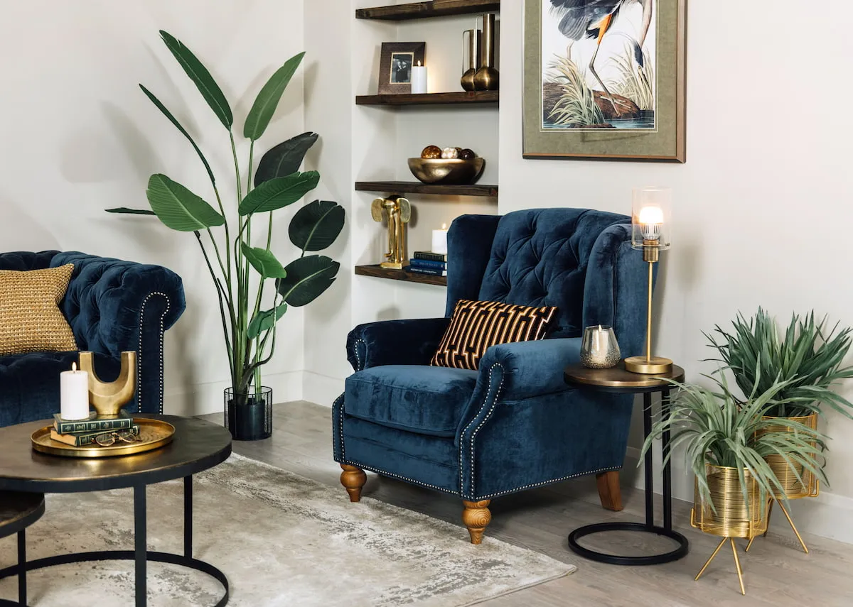 A lifestyle image of the Adare wing chair with toko side table peyton pots