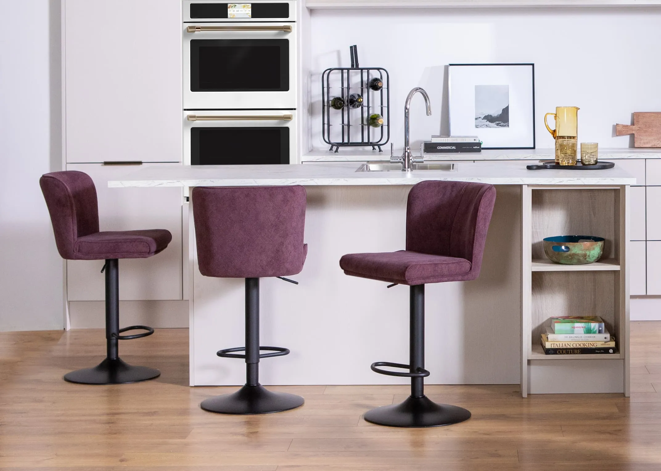 A lifestyle image of three Maple purple barstools at an island in a kichen setting.