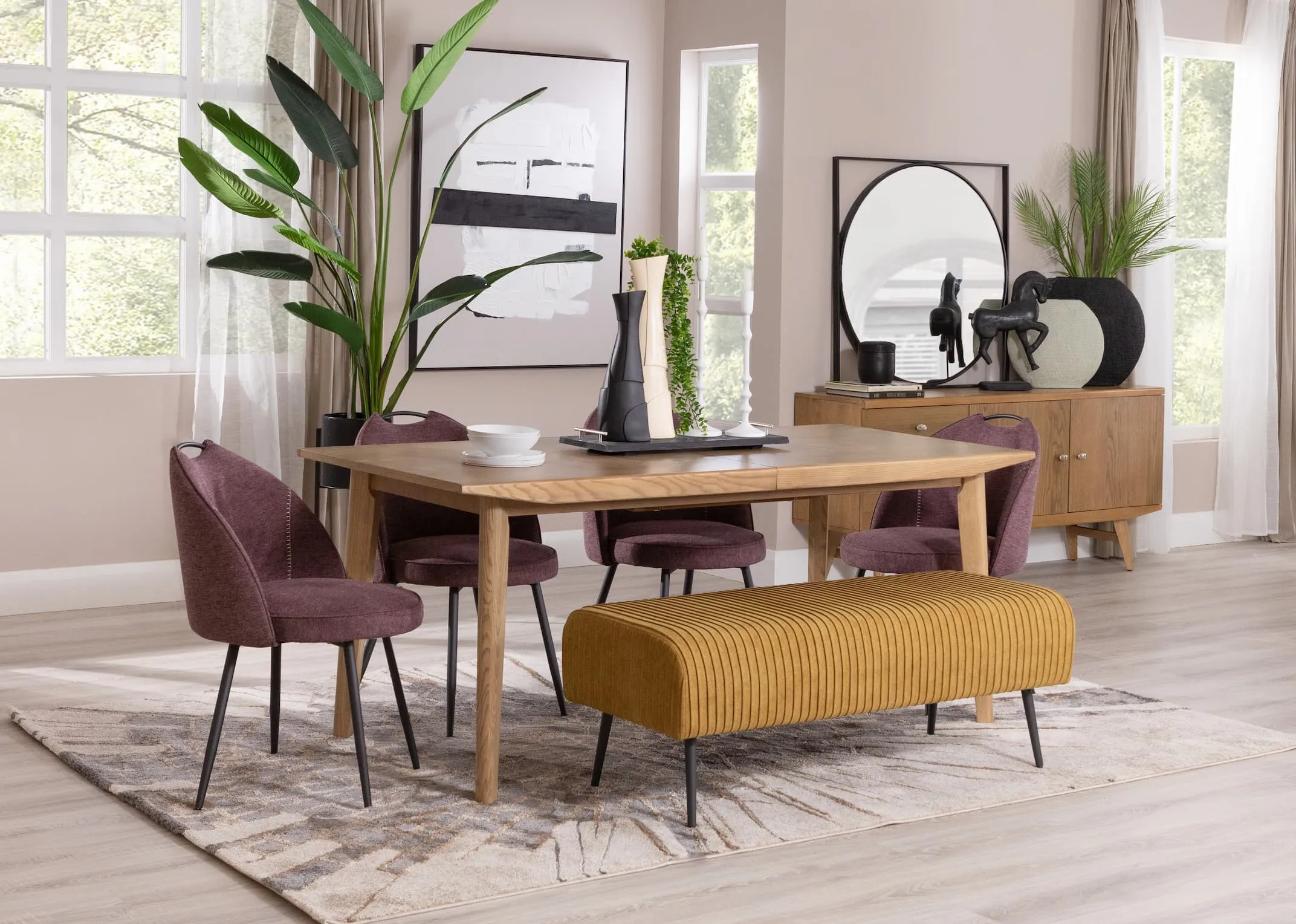 A lifetsyle image of the Ash dining table with Opal plum chairs & Marco bench