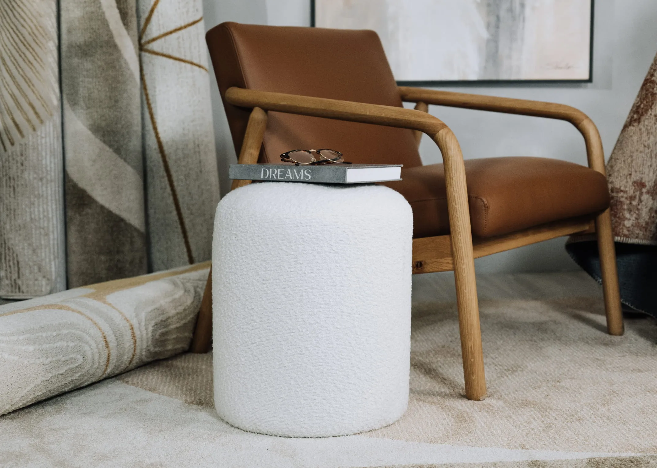 A lifestyle image of the Parker white footstool with the Fifi tan leather lounge chair.