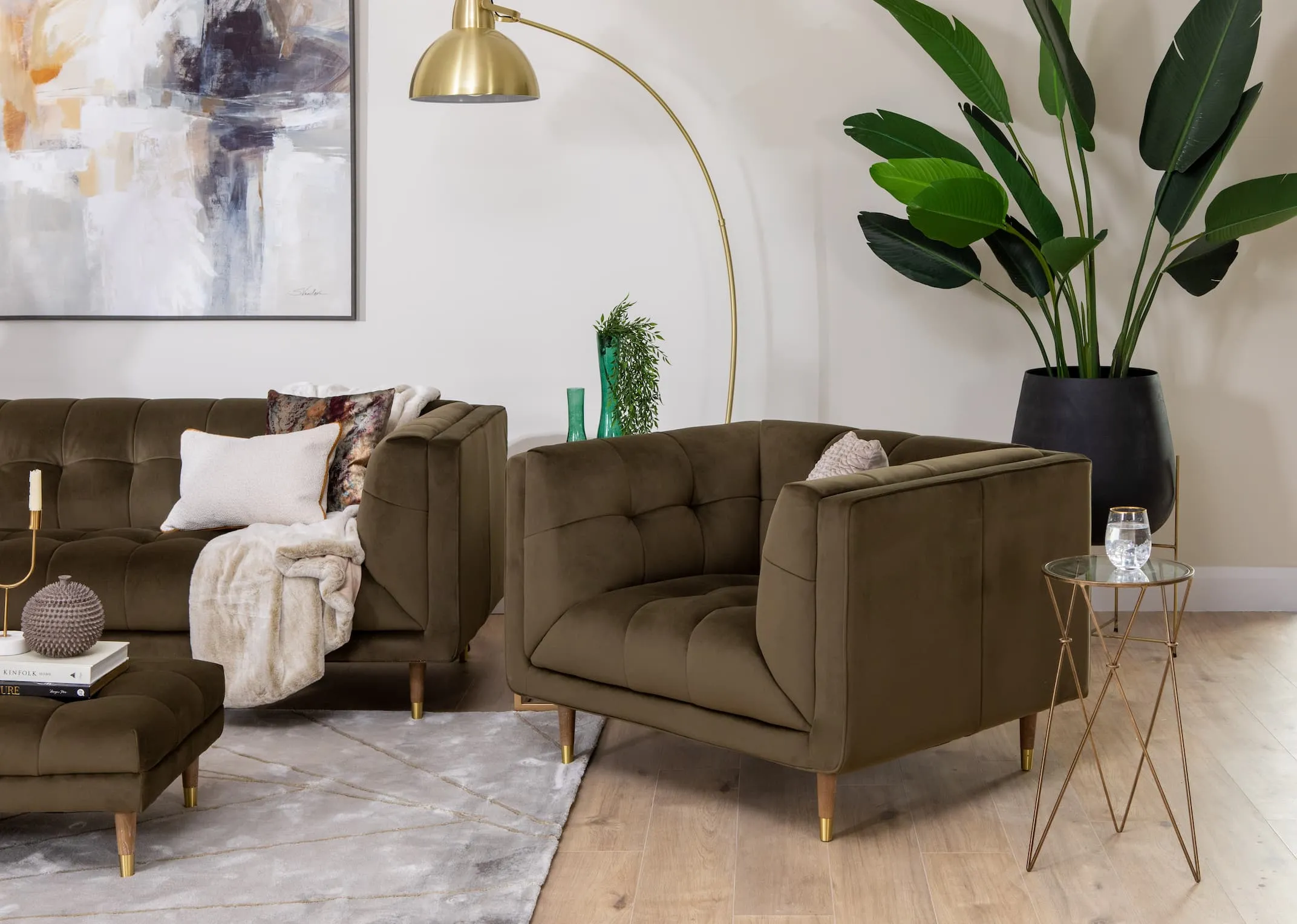 A lifestyle image of the Grace green velvet sofa with sofa and footstool and Fiona Lamp.