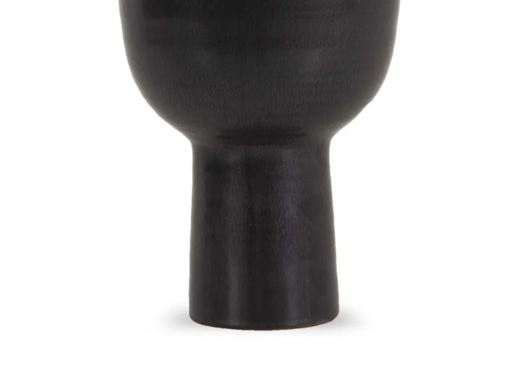 A slim matt black vase with long base from EZ Livings Shalwa range. Closeup of stem base.