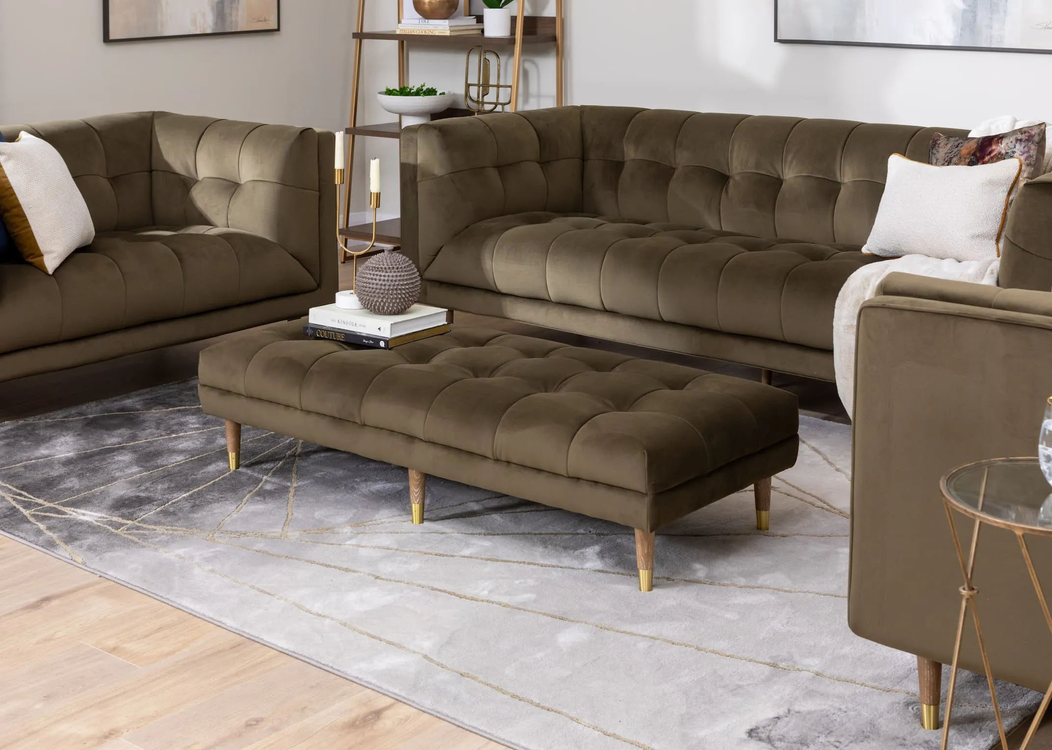 A lifestyle image of the Grace Velvet sofas & footstool with book