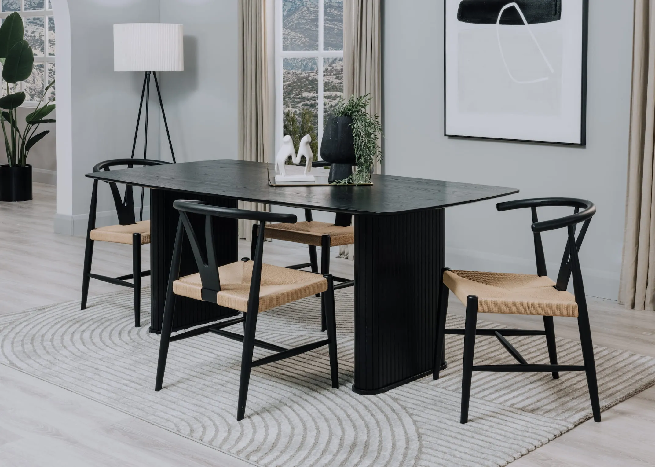 A lifestyle image of the Nola dining table with Cape woven chairs