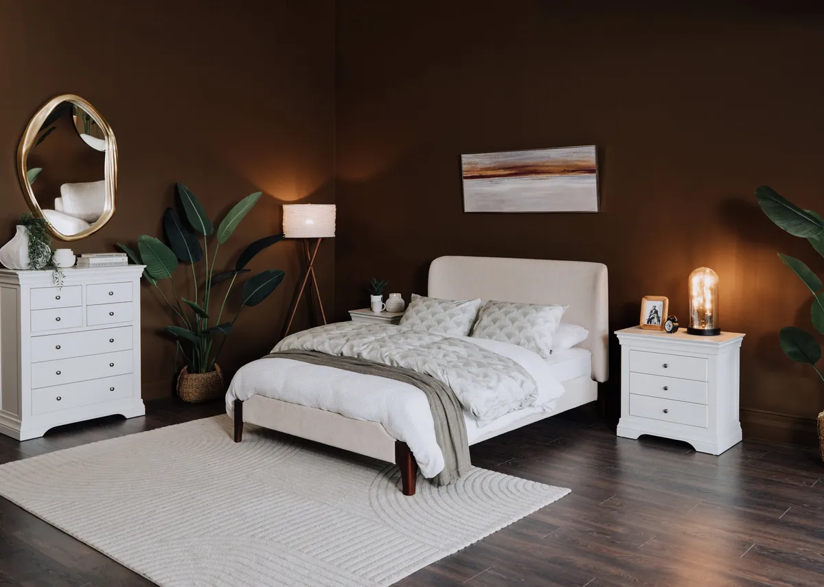 A lifestyle image of the Calm beige bedframe with Delfina mirror and Amelie chest and locker