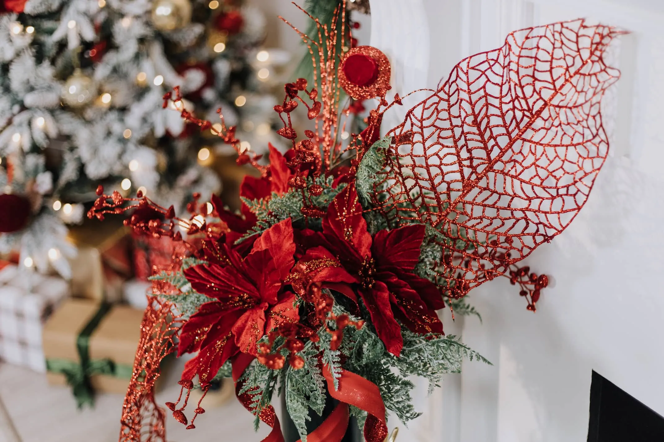 A lifetsyle image of a Foliage display in a vase with Red Branch & red leaf among others.