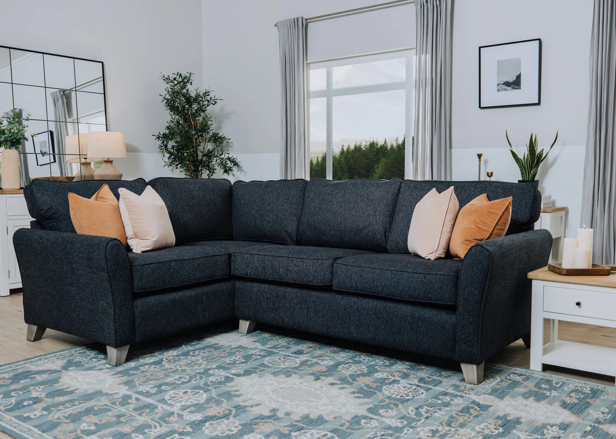 A lifetsyle image of the Turin corner sofa with Caserta rug and barleycove lamp table.
