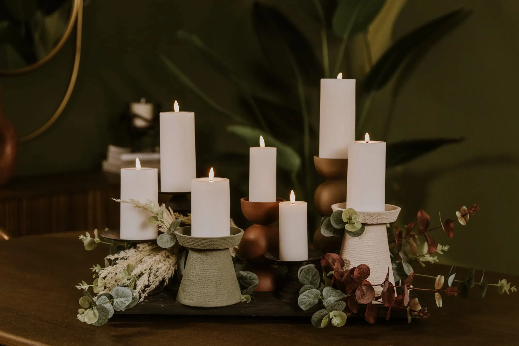 A lifestyle image of the Delight Candles with Decor pillar candle holders.