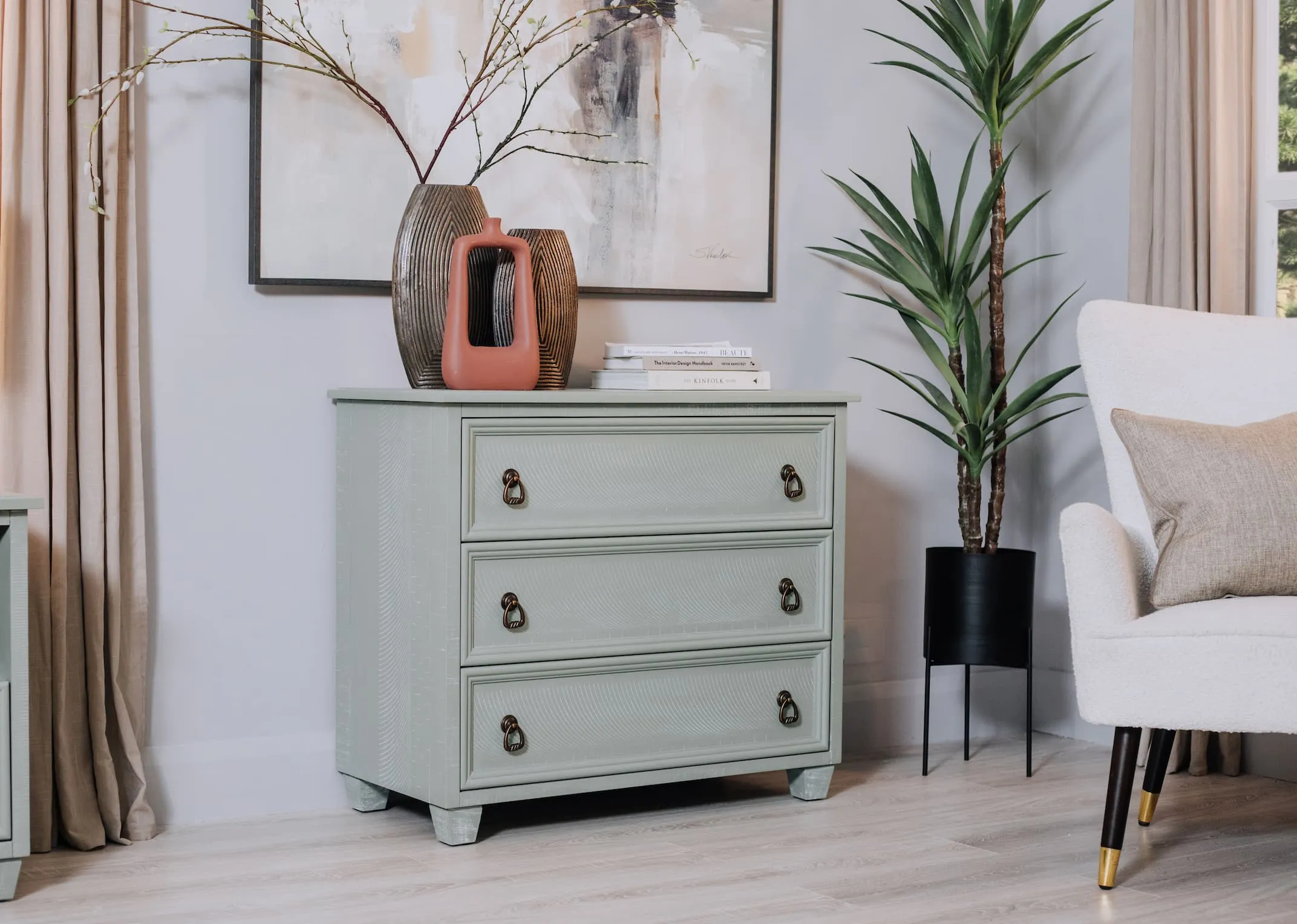 A lifetsyle image of the Grenoble chest of drawers with Terracotta vase and other vases from EZ Living Furniture.