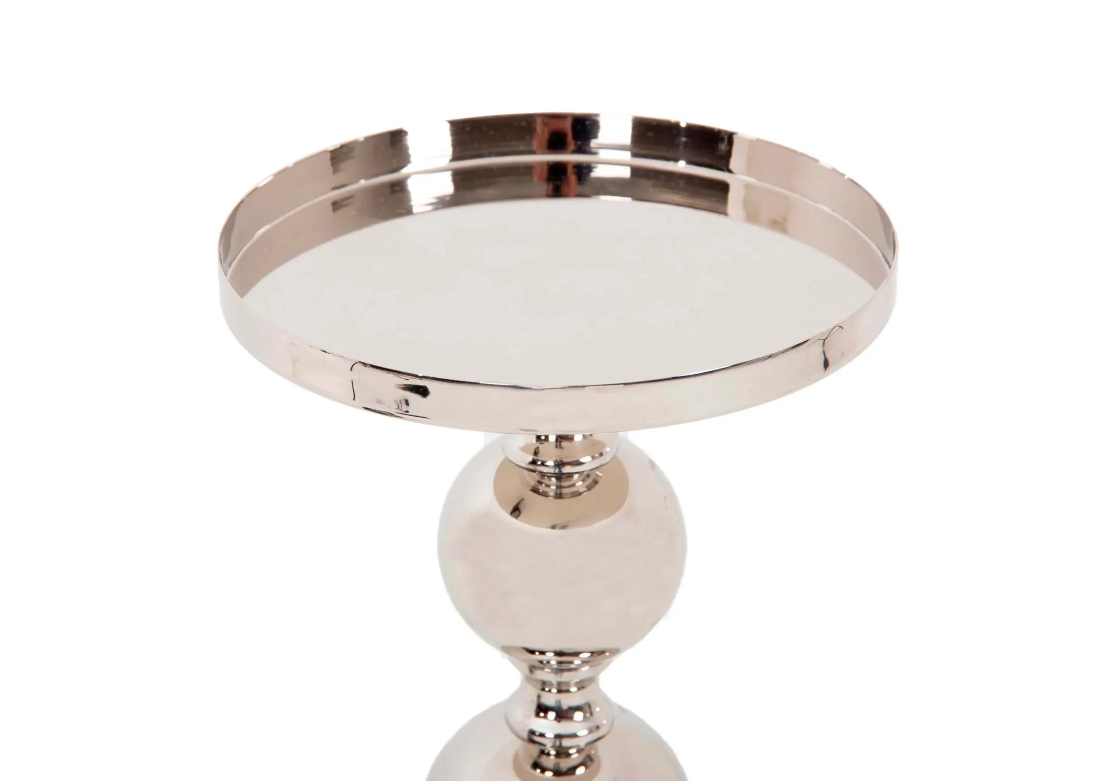 A lifestyle image of the Whiet Poinsettias in a vase with Silver Pillar Candle Stand.