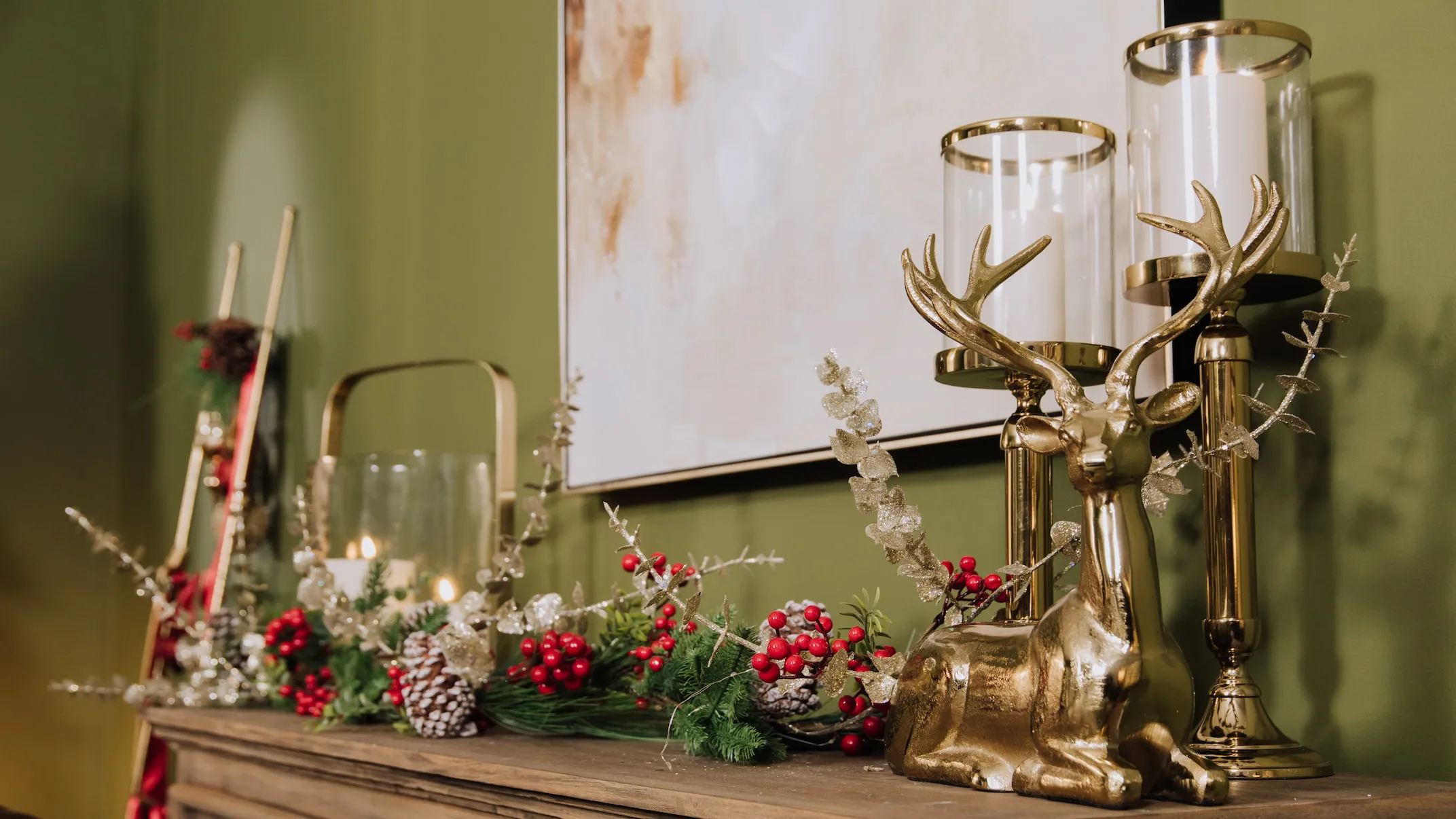 A lifetsyle image of a sideboard with Smooth Pillar Candleholders and sitted gold ornament.
