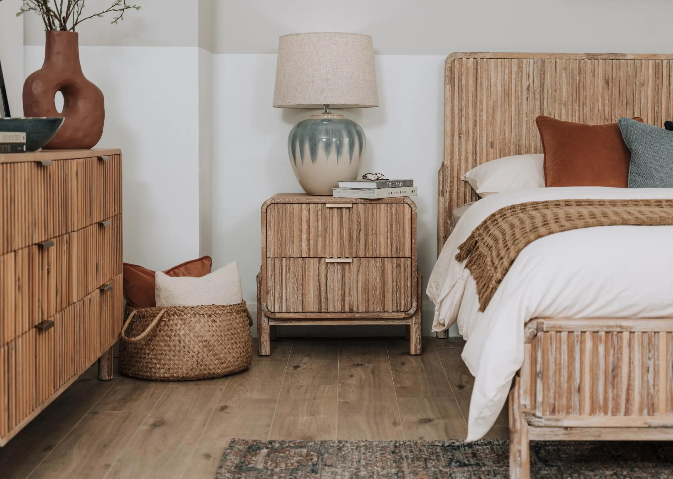 A lifestyle image of the Milo locker with matching bedframe and Renn table lamp.
