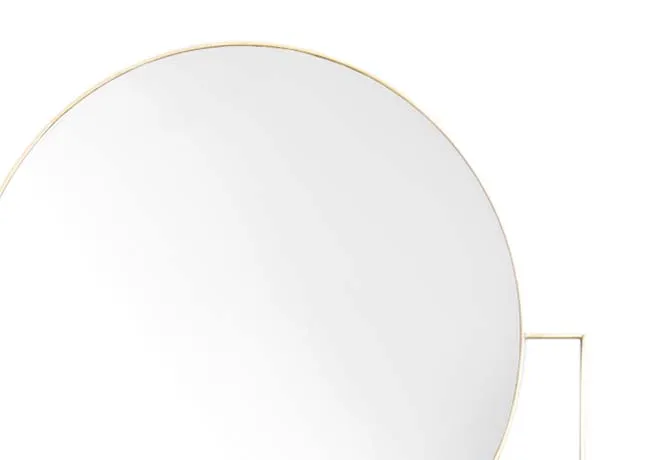 A gold tall mirror with circular top from EZ Livings Calista range. Closeup of gold trim.
